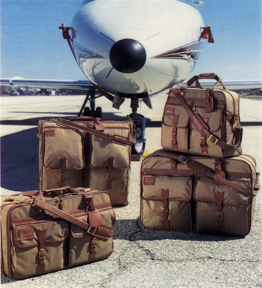 Travel luggage styled and arranged in front of lear jet on tarmac.Product Photography