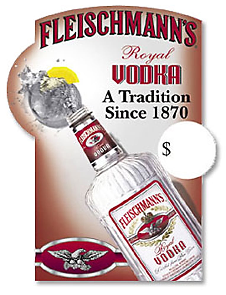 Top view of Large bottle of Fleischmann's Vodka pouring into rock glass with splash and lemon on ad poster Product Photography