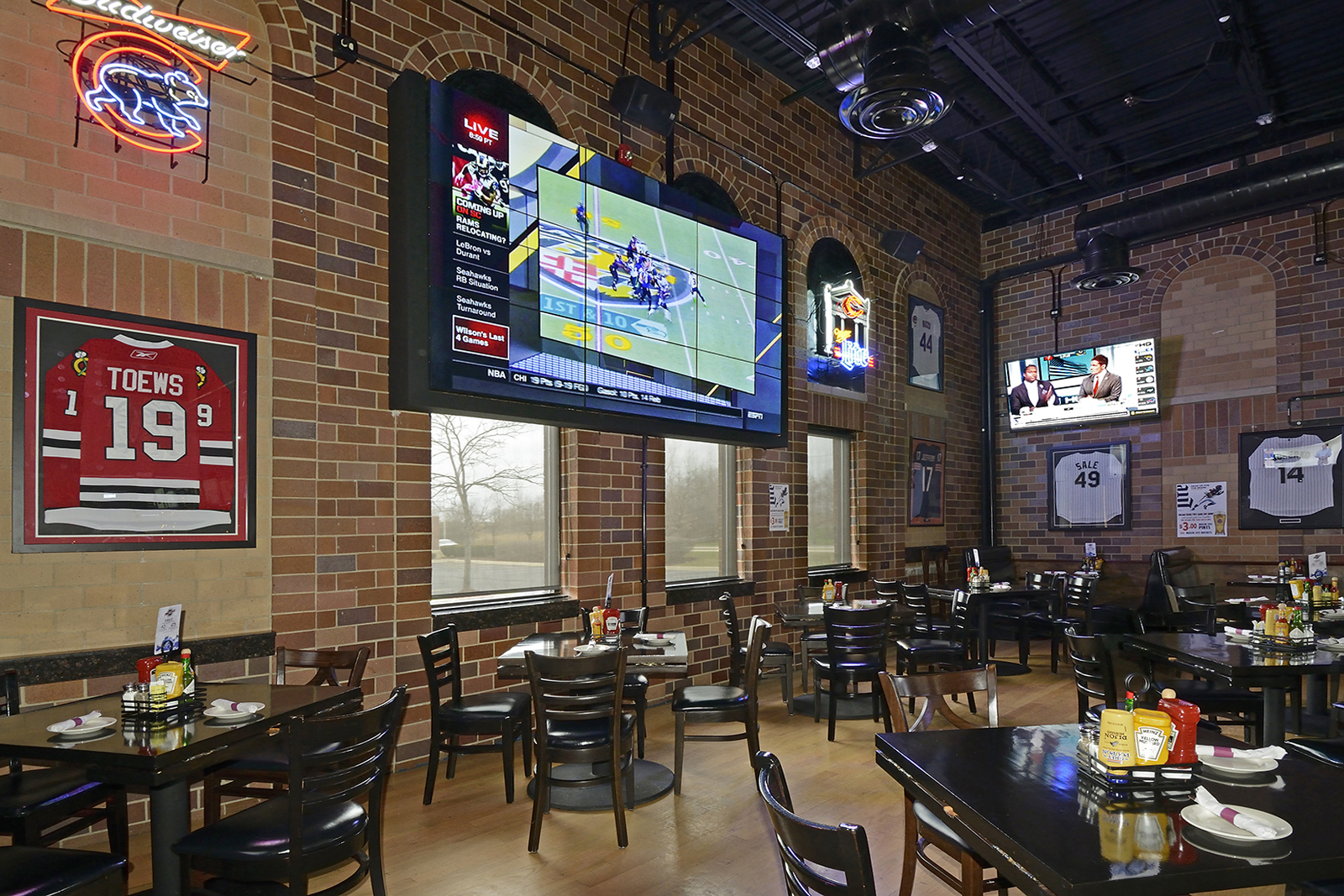 interior shot of sports bar featuring large tv screens