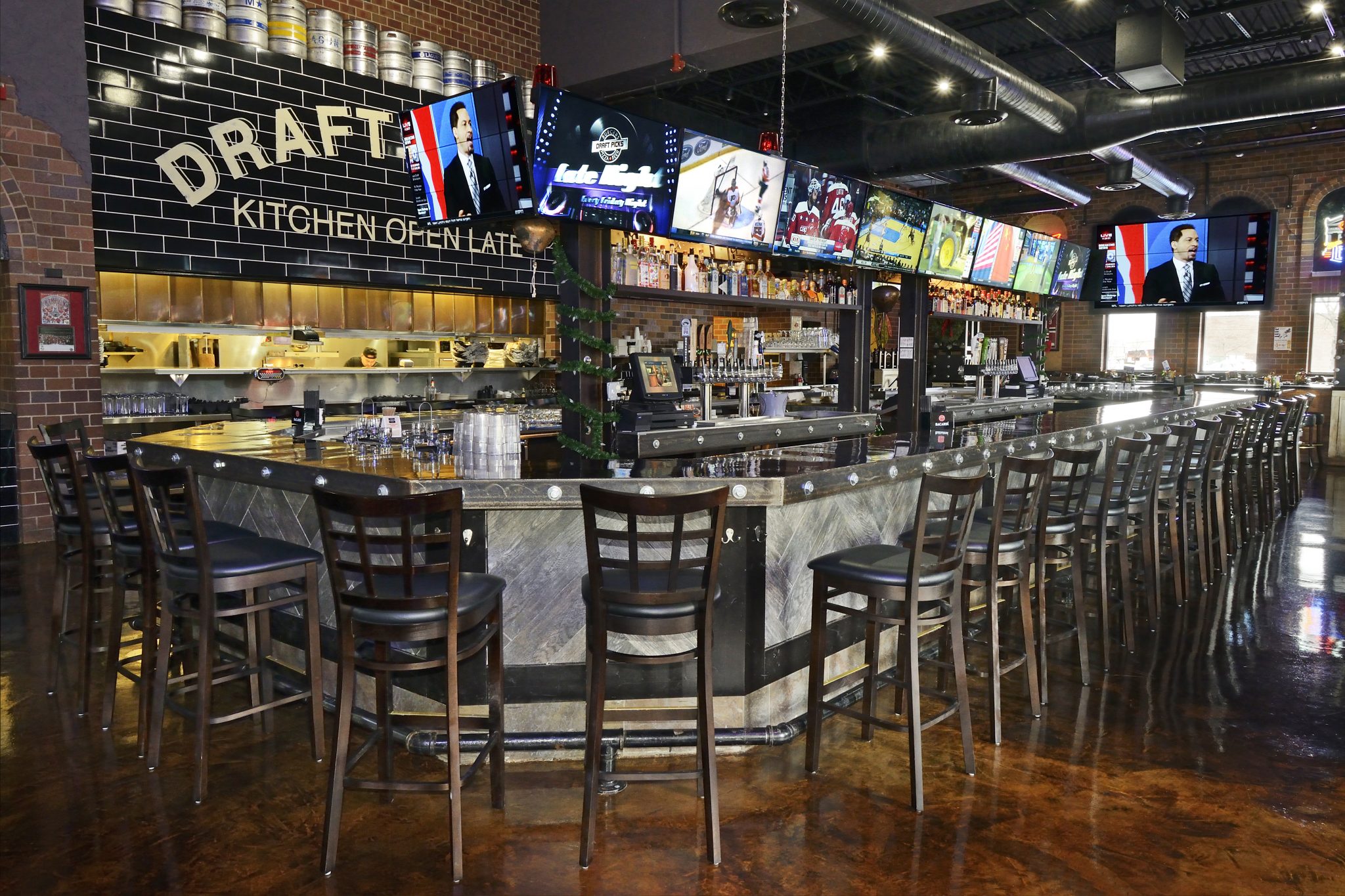 interior shot of sports bar featuring large tv screens